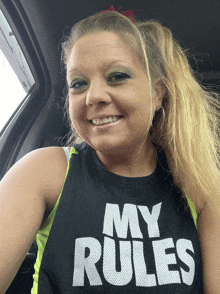 a woman wearing a shirt that says my rules smiles for the camera