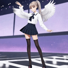 a girl with angel wings is standing on a stage .