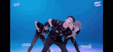 a group of young men are dancing together on a blue background .