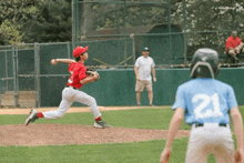 a baseball player with the number 21 on his back is about to throw the ball