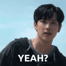 a man in a black shirt is making a face and says yeah