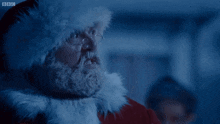 a close up of a man dressed as santa claus with the bbc logo on the bottom