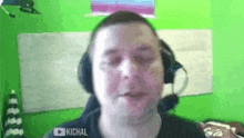 a man wearing headphones and a microphone is talking on a video call .