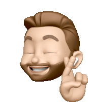 a man with a beard is smiling and giving the peace sign