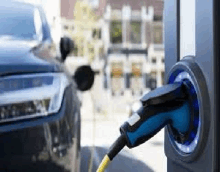 an electric vehicle is being charged at a charging station .