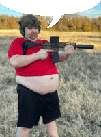 a man in a red shirt and black shorts is holding a gun and pointing at it