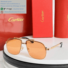 a pair of cartier sunglasses sitting on a white table