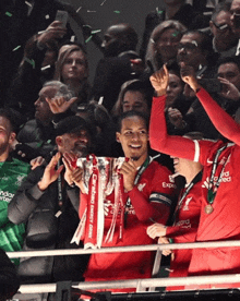 a group of soccer players holding a trophy that says carlsberg energy