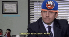 a man in a suit and tie wearing a new york islanders hat says " i am ready to get hurt again "