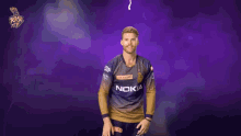 a man in a nokia shirt stands in front of a purple backdrop