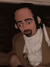 a man with a beard wearing a brown jacket and white shirt
