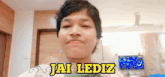 a young man is making a funny face and the words jai lediz are above his head