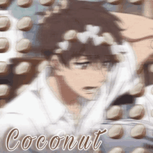 a blurry picture of a boy with coconuts on his head and the word coconut on the bottom .