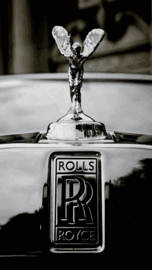 a rolls royce emblem with a statue on top of it