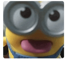 a close up of a toy minion with its tongue sticking out .