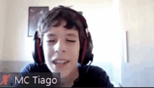 a young boy wearing headphones is on a video call with the name mc tiago