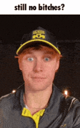 a man wearing a baseball cap and a jacket says still no bitches .