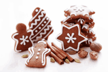 a stack of gingerbread cookies with cinnamon sticks and nutmeg on a table