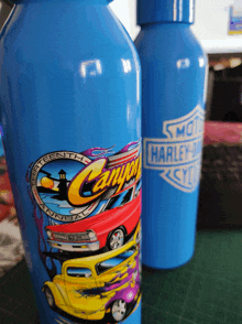 two blue water bottles with canyon annual on them