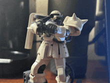 a toy robot with a gun and a backpack