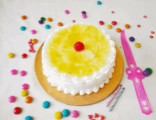 a pineapple cake with a cherry on top sits on a table