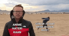 a man wearing glasses and a red and black jacket with the words anime hateri kaan written on it