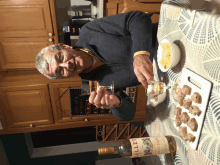 a man is sitting at a table with a bottle of millet on it