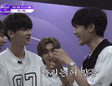 a group of young men are standing in front of a sign that says planet