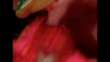 a close up of a person 's mouth with a waffle cone in it and a flower in the background .