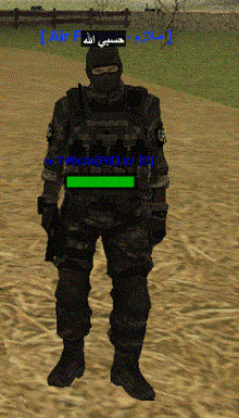 a soldier in a video game is standing in the sand with arabic writing on the screen behind him