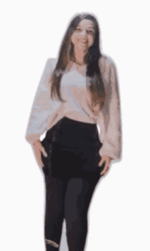 a woman in a white sweater and black skirt