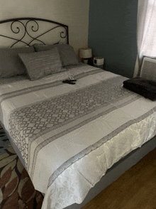 a bed with a patterned blanket and pillows