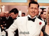 a man in a tuxedo says gorlami in front of a crowd of people