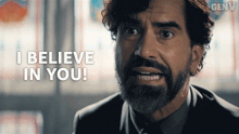 a man in a suit and tie says i believe in you