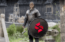 a man with a beard is holding an axe and shield