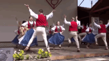 a group of people are dancing on a stage in front of a sign that says ' a ' on it