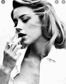 a black and white photo of a woman smoking