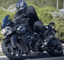 a man wearing a helmet is riding a motorcycle