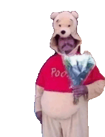 a man in a winnie the pooh costume holds flowers