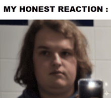 a man taking a picture of himself with a caption that says " my honest reaction "