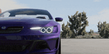 a purple ford car is parked in a parking lot with trees in the background