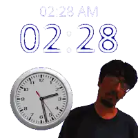 a man stands in front of a clock that says 2.28 am