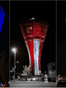 a water tower is lit up in red white and blue colors