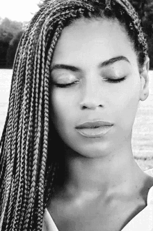 a black and white photo of a woman with braids