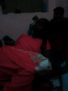 a person laying on a bed with a red blanket on