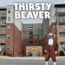 a man in front of a building with thirsty beaver written on it