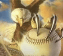 a close up of a baseball with a bird 's claws on it .