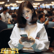 a woman wearing glasses and a white shirt that says museum eola