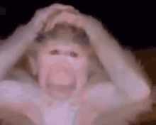 a monkey is making a funny face with its mouth open in a blurry photo .