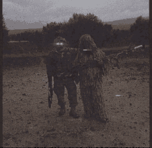 two soldiers are standing next to each other in a field